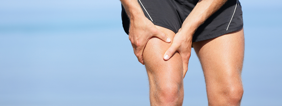 Male athlete holding thigh injury
